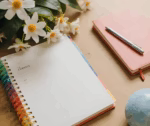 a planner on a clean desk with flowers